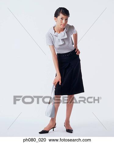 Young woman carrying handbag, hand on hip View Large Photo Image Stock Image - Young woman carrying handbag, hand on hip. Fotosearch