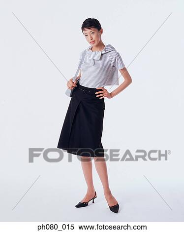 Young woman carrying handbag, hand on hip View Large Photo Image Stock Photography - Young woman carrying handbag, hand on hip . Fotosearch