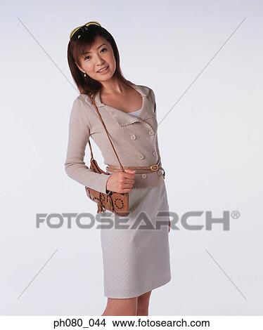 Young woman carrying handbag, posing View Large Photo Image Picture - Young woman carrying handbag, posing. Fotosearch