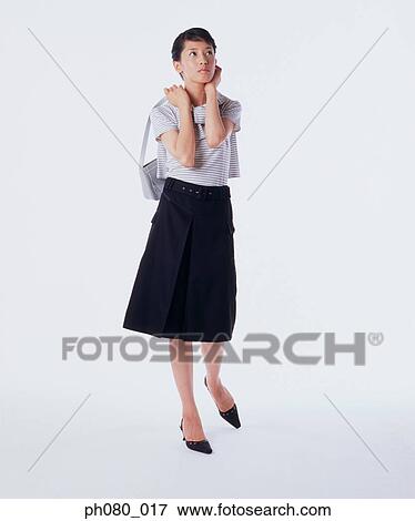 Young woman carrying handbag, posing View Large Photo Image Stock Photo - Young woman carrying handbag, posing. Fotosearch