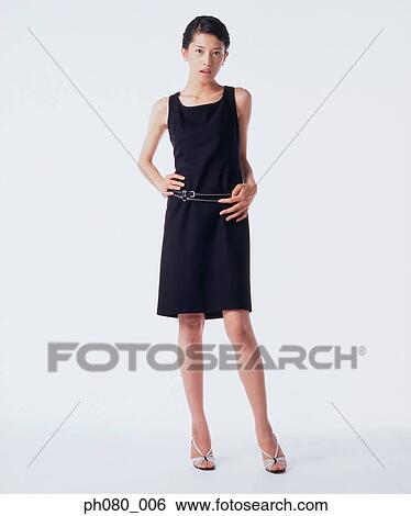 Young woman standing with hands on hips View Large Photo Image Stock Photograph - Young woman standing with hands on hips . Fotosearch