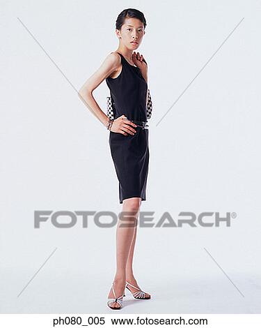 Young woman standing with hands on hips View Large Photo Image Stock Photography - Young woman standing with hands on hips . Fotosearch
