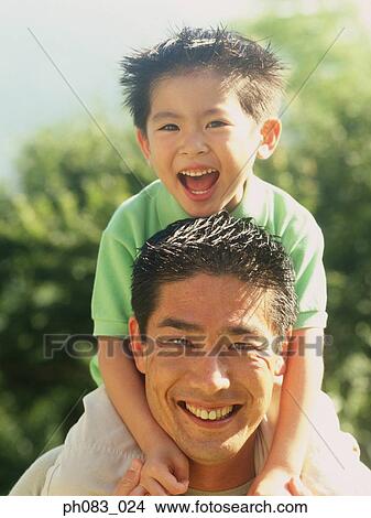 Picture - Boy on father's shoulders, close-up. Fotosearch