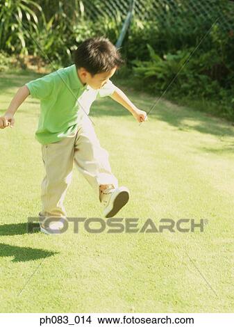 Boy playing in garden View Large Photo Image Picture - Boy playing in garden. Fotosearch