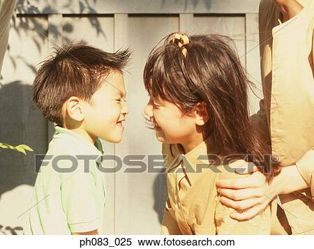 Stock Photography - Brother and sister making monkey faces. Fotosearch