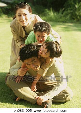 Family of four in a park View Large Photo Image Stock Photography - Family of four in a park. Fotosearch