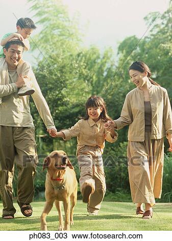 Family walking dog in park View Large Photo Image Stock Image - Family walking dog in park . Fotosearch