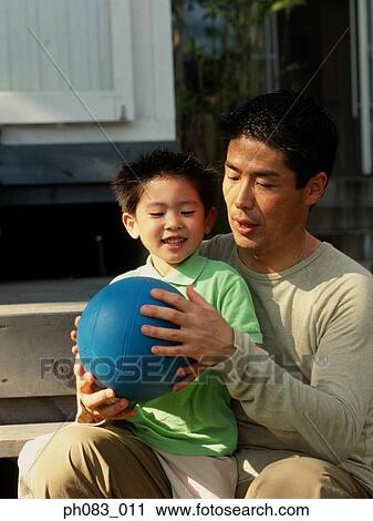 Father and son playing ball games View Large Photo Image Stock Image - Father and son playing ball games. Fotosearch