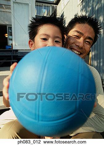 Stock Image - Father and son playing ball games. Fotosearch