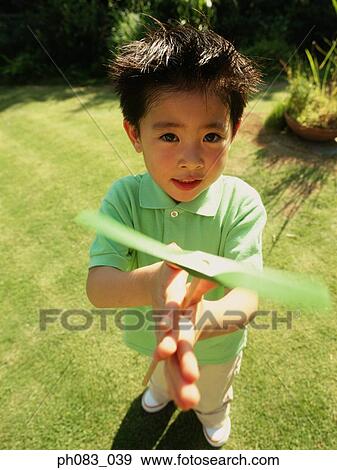 Young boy playing with toy View Large Photo Image Stock Photo - Young boy playing with toy. Fotosearch