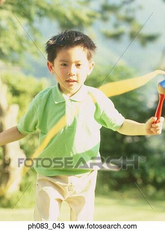 Young boy skipping View Large Photo Image Stock Image - Young boy skipping. Fotosearch