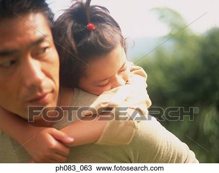 Young daughter having a piggyback from her father, sleeping View Large Photo Image Stock Image - Young daughter having a piggyback from her father, sleeping. Fotosearch
