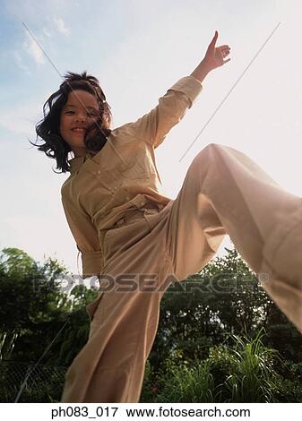 Young girl posing, low angle view View Large Photo Image Stock Photo - Young girl posing, low angle view. Fotosearch