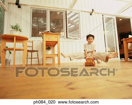 Brother playing with wooden toy car View Large Photo Image Stock Image - Brother playing with wooden toy car. Fotosearch