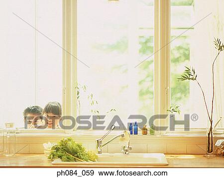 Stock Photo - Children peeking into kitchen. Fotosearch