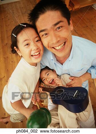 Stock Image - Father and children playing. Fotosearch