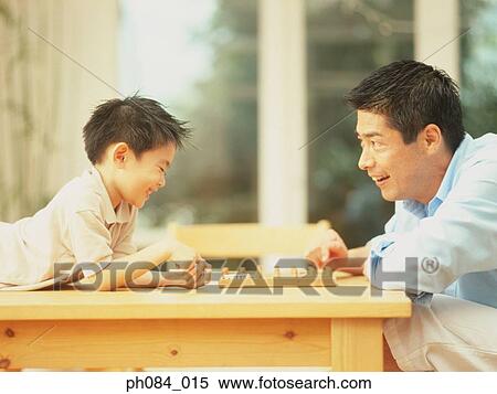 Father and son playing board game View Large Photo Image Stock Photography - Father and son playing board game. Fotosearch