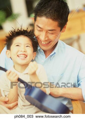 Father and son playing toy guitar View Large Photo Image Stock Image - Father and son playing toy guitar. Fotosearch