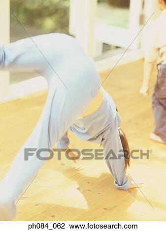 Girl turning somersault View Large Photo Image Stock Image - Girl turning somersault. Fotosearch