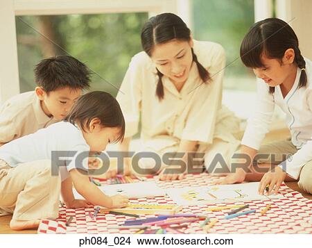 Mother and children drawing using crayon View Large Photo Image Picture - Mother and children drawing using crayon. Fotosearch