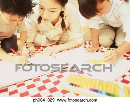 Mother and children drawing using crayon View Large Photo Image Stock Photo - Mother and children drawing using crayon. Fotosearch