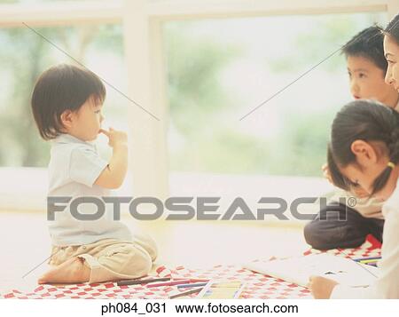 Mother and children painting, boy sucking finger View Large Photo Image Stock Image - Mother and children painting, boy sucking finger. Fotosearch