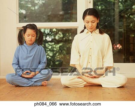 Stock Photograph - Mother and son meditating. Fotosearch