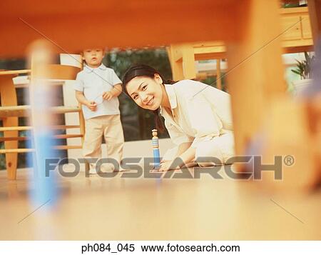 Mother and son playing wooden toy View Large Photo Image Stock Photography - Mother and son playing wooden toy. Fotosearch