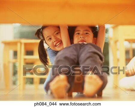 Sister and brother playing wooden toy car View Large Photo Image Picture - Sister and brother playing wooden toy car. Fotosearch