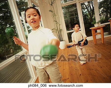 Sister playing Maracas and brother toy guitar View Large Photo Image Stock Photograph - Sister playing Maracas and brother toy guitar. Fotosearch