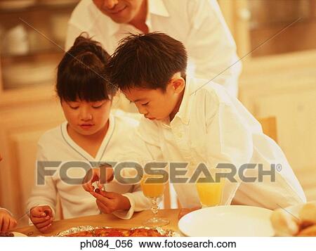 Young brother taking grape from sister View Large Photo Image Stock Photograph - Young brother taking grape from sister. Fotosearch