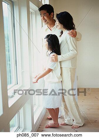 Family looking through window View Large Photo Image Stock Photo - Family looking through window. Fotosearch