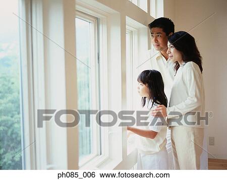 Stock Photograph - Family looking through window. Fotosearch