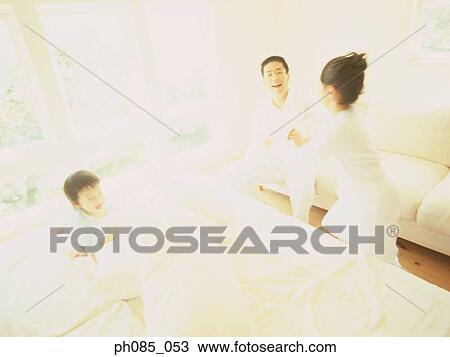 Family playing in bedroom View Large Photo Image Stock Image - Family playing in bedroom. Fotosearch