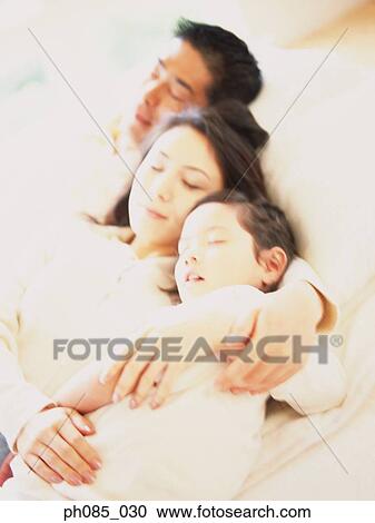 Family sleeping together View Large Photo Image Stock Image - Family sleeping together. Fotosearch