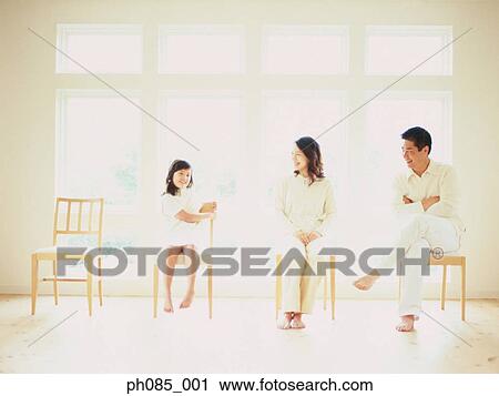 Father, mother and daughter sitting on chairs View Large Photo Image Stock Image - Father, mother and daughter sitting on chairs. Fotosearch