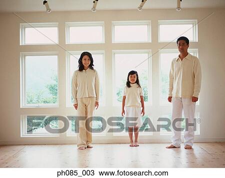 Father, mother and daughter standing at home View Large Photo Image Stock Image - Father, mother and daughter standing at home. Fotosearch