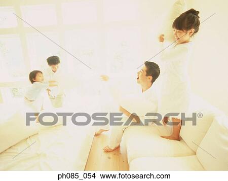 Picture - Father playing with children in bedroom. Fotosearch