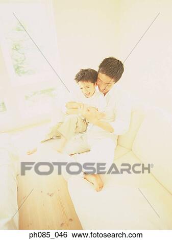 Stock Photograph - Father playing with son. Fotosearch