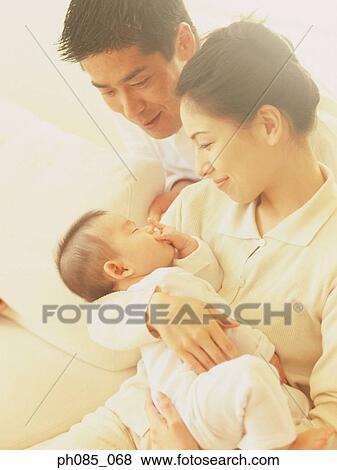 Stock Photo - Parents and a newborn baby. Fotosearch