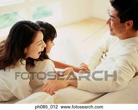Parents and daughter playing on sofa View Large Photo Image Stock Image - Parents and daughter playing on sofa. Fotosearch