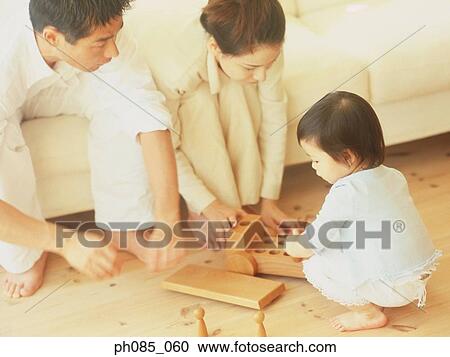 Parents and son playing with wooden toy View Large Photo Image Stock Image - Parents and son playing with wooden toy. Fotosearch