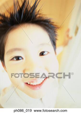 Stock Photo - Boy with spiked hair smiling, portrait, close-up . Fotosearch