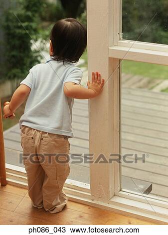 Girl looking out of door, waiting View Large Photo Image Stock Image - Girl looking out of door, waiting. Fotosearch
