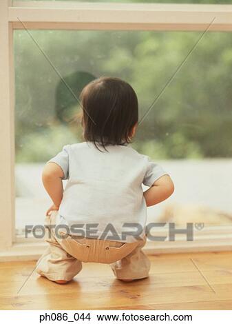 Picture - Girl looking out of window. Fotosearch