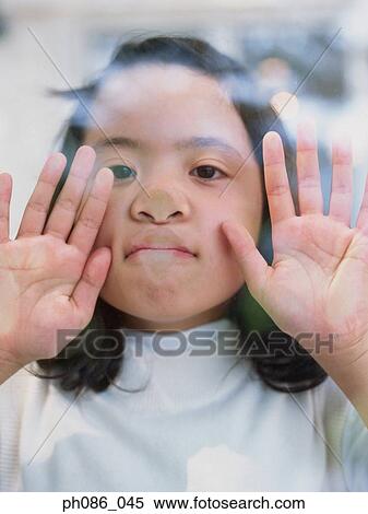 Girl peering through window, portrait View Large Photo Image Stock Photography - Girl peering through window, portrait . Fotosearch