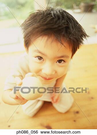 Little boy holding ball, high angle view View Large Photo Image Stock Photograph - Little boy holding ball, high angle view. Fotosearch