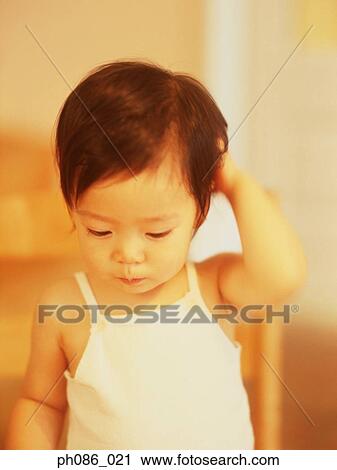 Little girl scratching head View Large Photo Image Stock Image - Little girl scratching head. Fotosearch