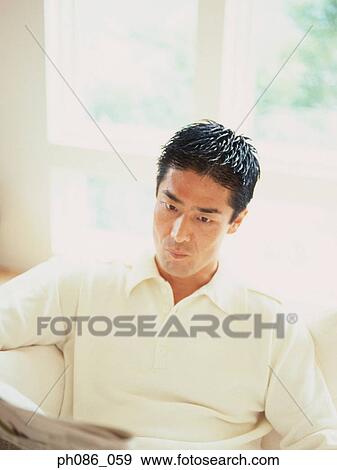 Stock Photo - Man reading newspapers. Fotosearch
