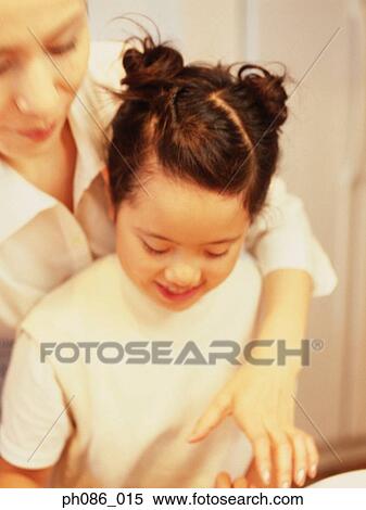 Mother coaching daughter View Large Photo Image Stock Photography - Mother coaching daughter. Fotosearch